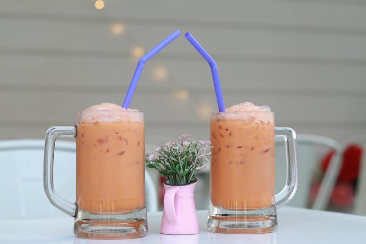 A Flower Vase In The Middle Of Iced Beverages
