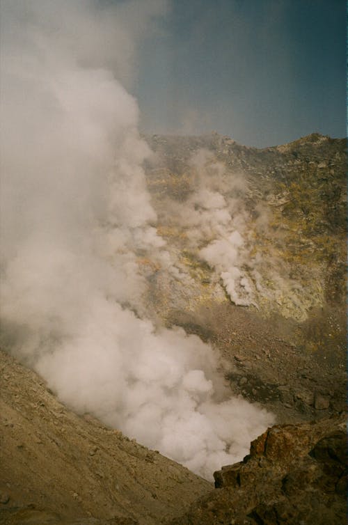 Vapors Rising from Among the Rocks Inside the Volcano Crater