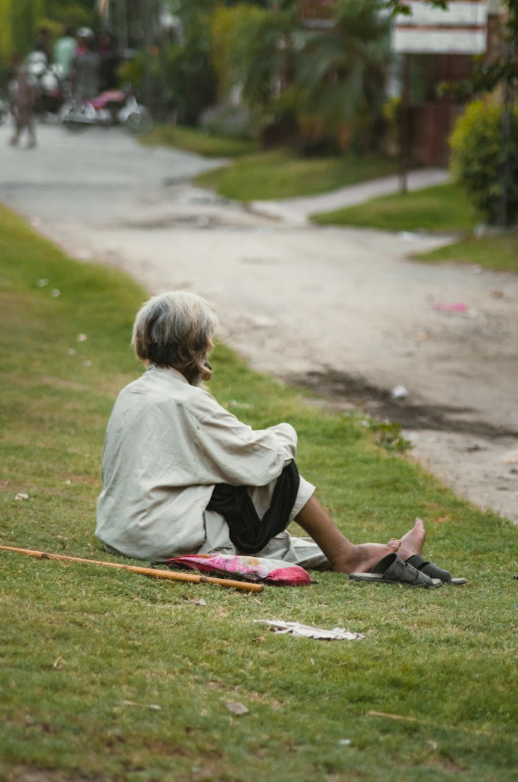 A Person Sitting On The Grass