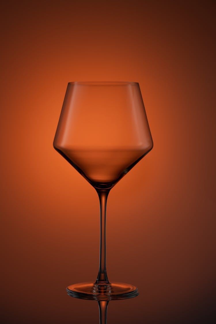 Wine Glass On Red Studio Background