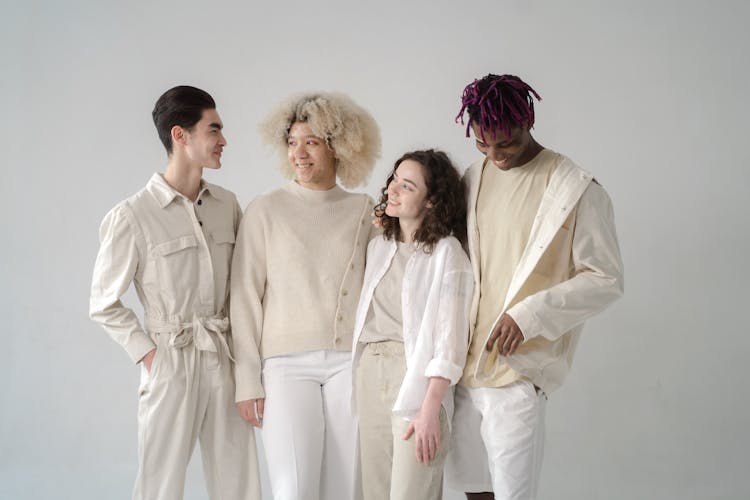 Group Of People In Beige And White Outfits