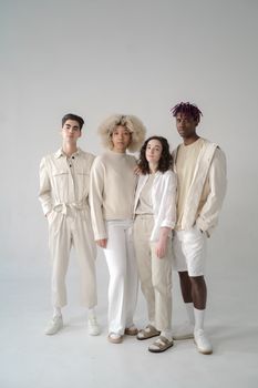 A diverse group of models showcasing modern fashion in a studio setting.