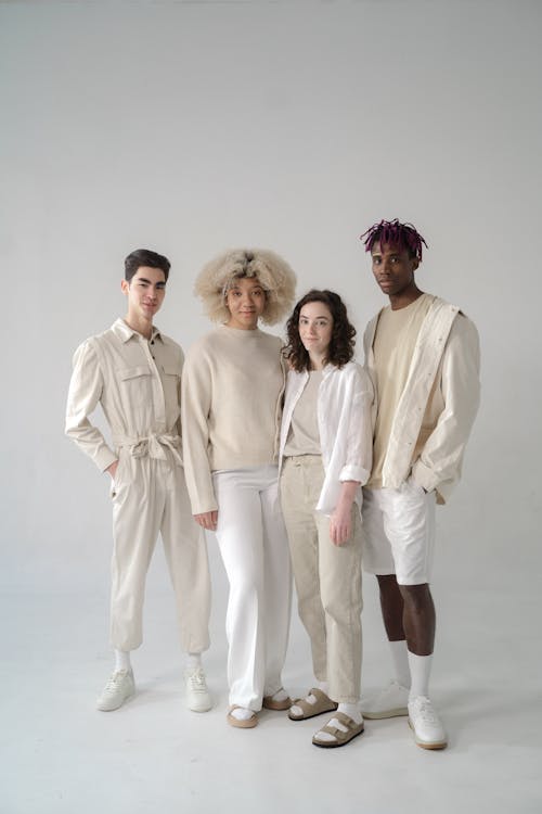 Men and Women in Beige and White Outfits