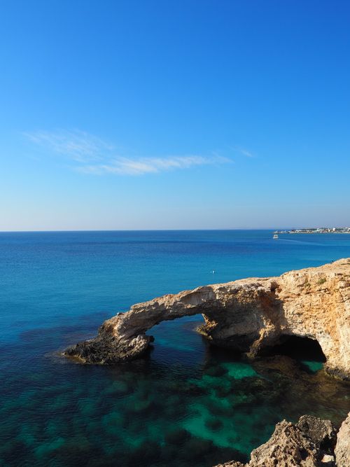 Free Beautiful view of the Mediterranean Sea and a natural rock arch along the coast of Cyprus. Stock Photo