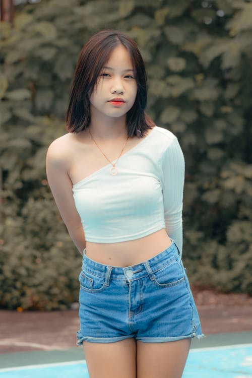 A Woman Wearing a White Crop Top and Shorts · Free Stock Photo