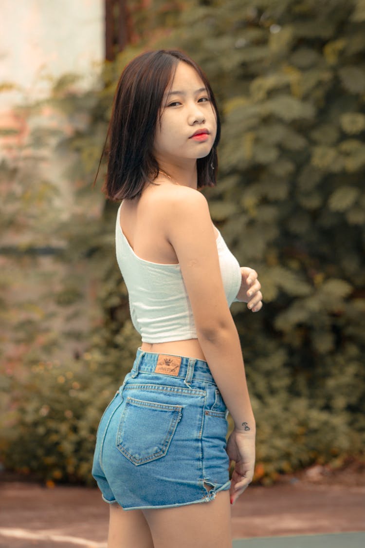 Girl Posing In Jeans Shorts And Crop Top