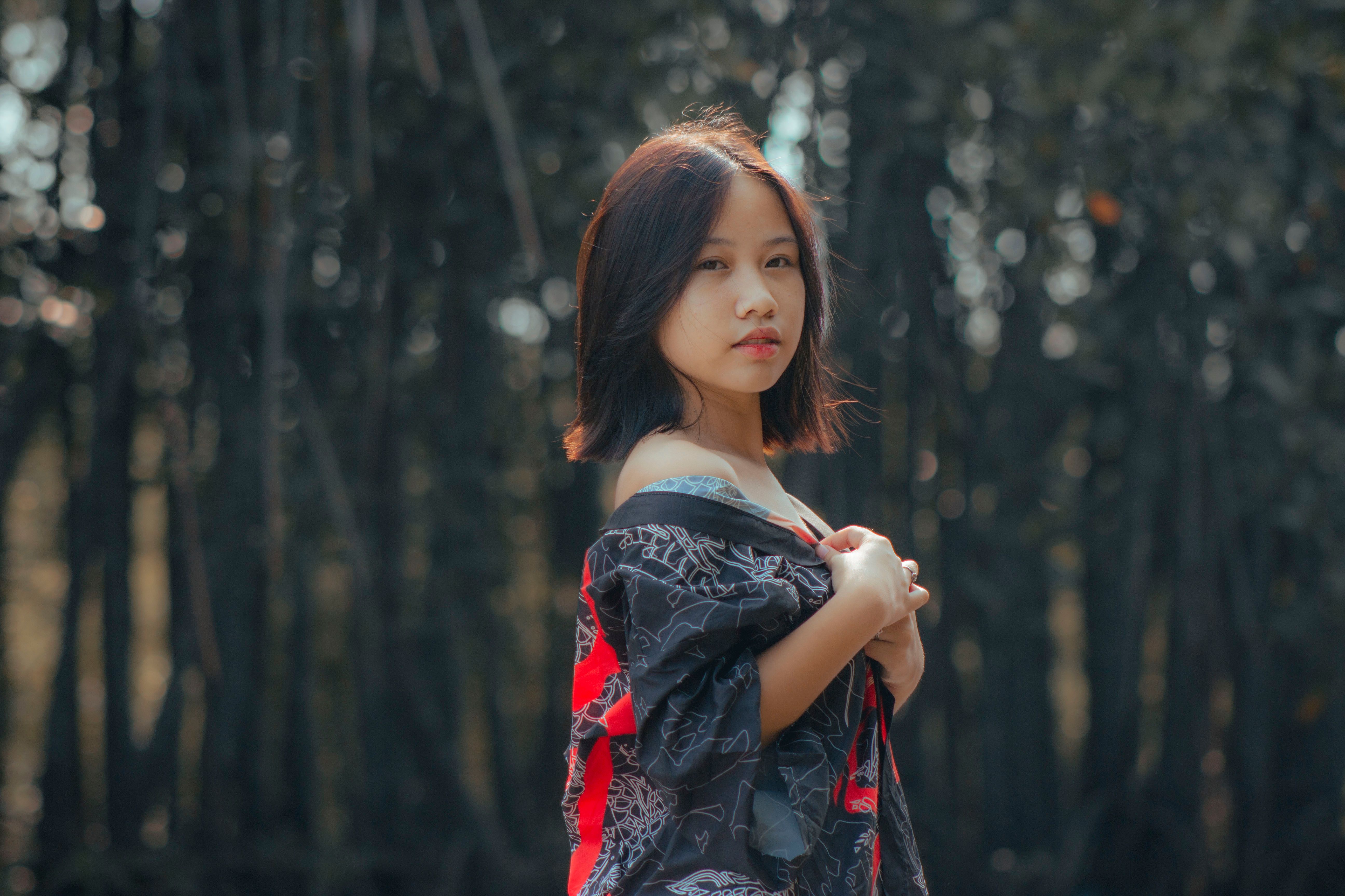 Photograph of a Girl in a Black and Red Shirt Posing · Free Stock Photo