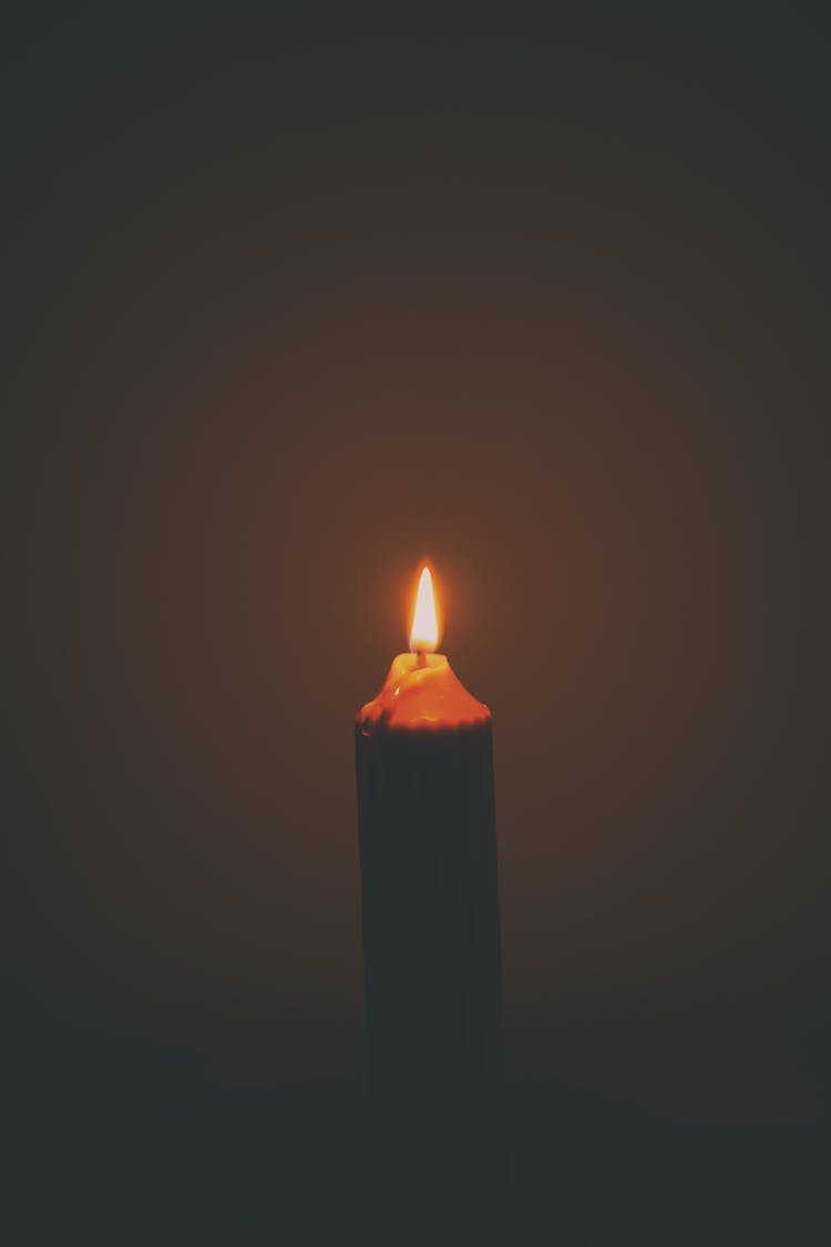 Lit Up Candle In Dark