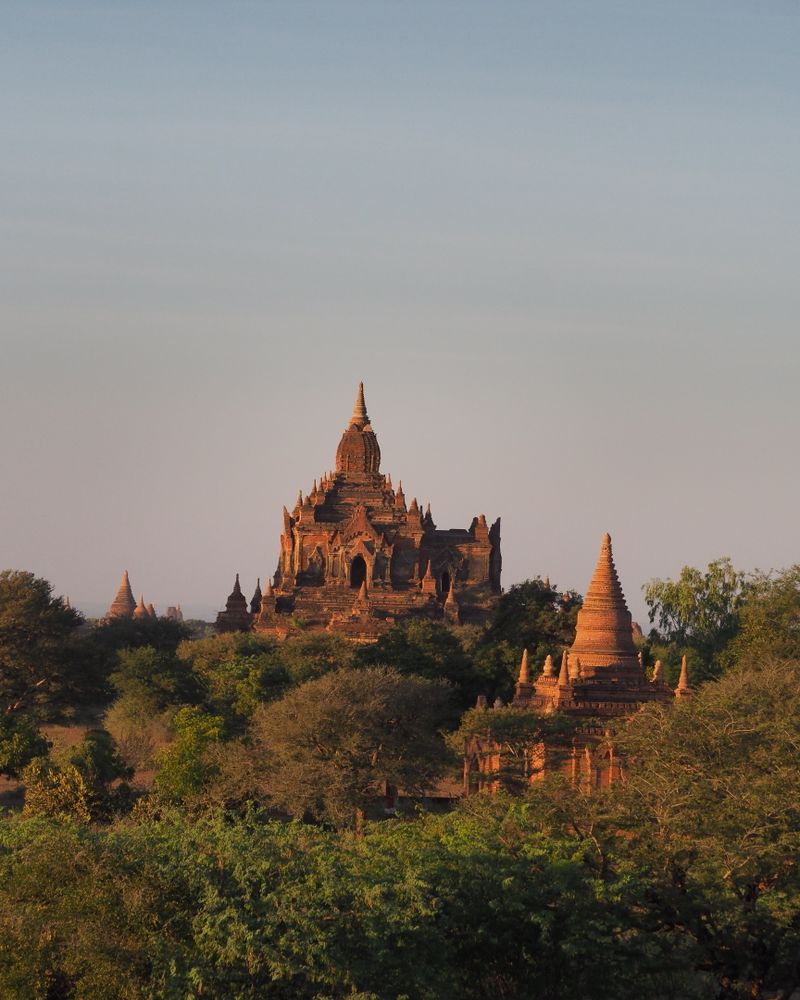 Ancient temples rising above the plains of Bagan, Myanmar, at sunset
