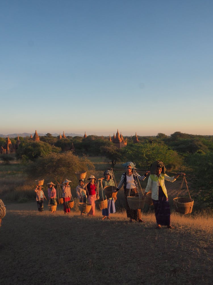 People Carrying Baskets With Crops In East Asia