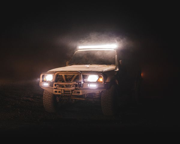 Off-road vehicle with auxiliary light bar at night
