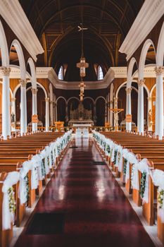 A beautifully decorated church interior with pews adorned for a special event, capturing the grand architectural design.