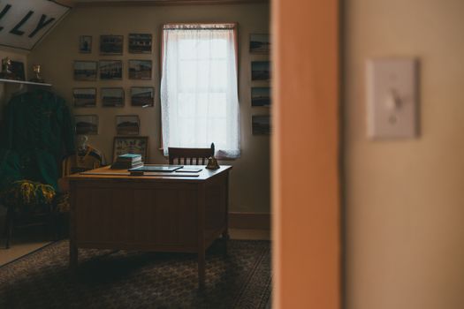 A cozy retro study room featuring a wooden desk with vintage decor, creating a nostalgic atmosphere.