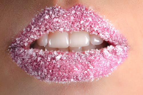 Free white granules on person lips stock photo