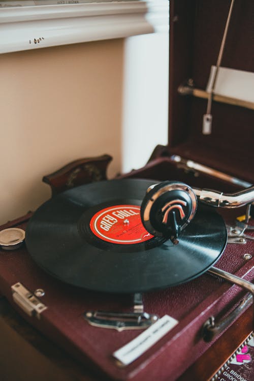 Close-up Photo Black Vinyl Record playing on a Phonograph