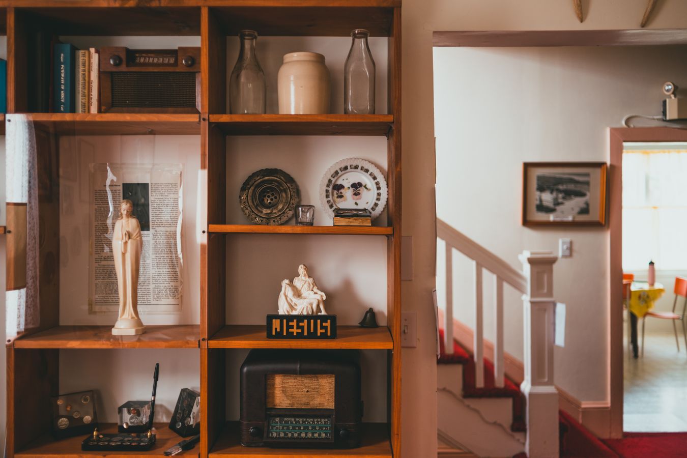 Wood shelving compartments displaying books and decorative objects