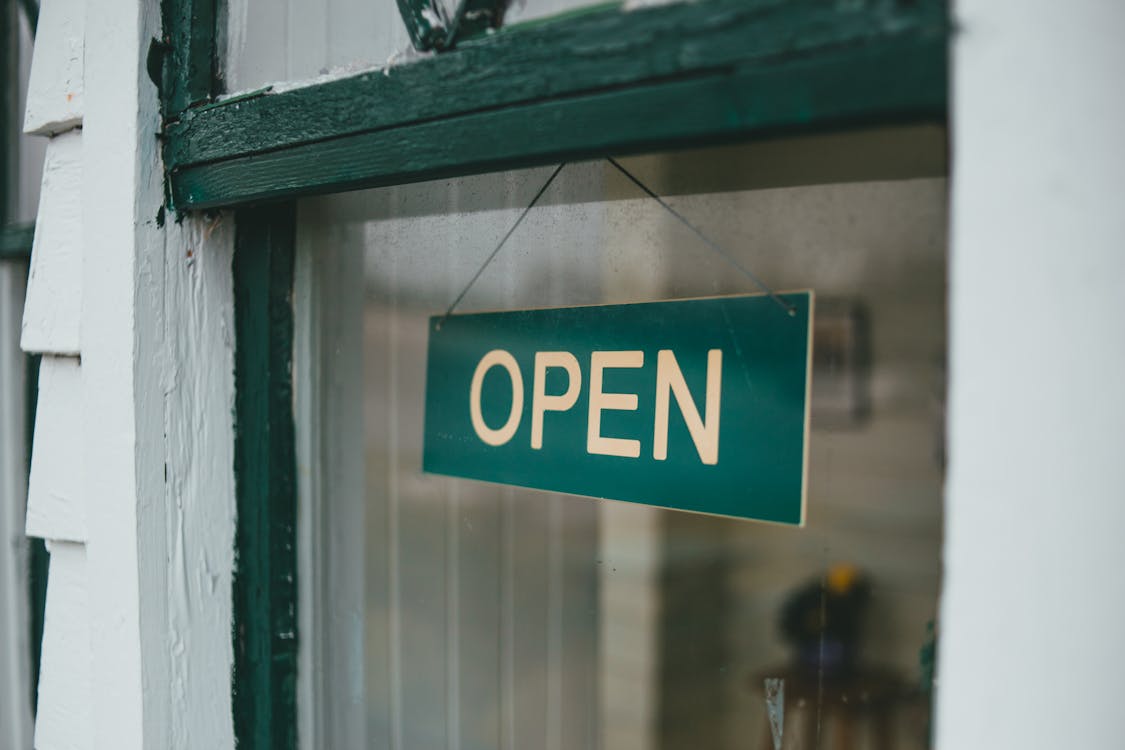A Blue Open Sign on the Window · Free Stock Photo