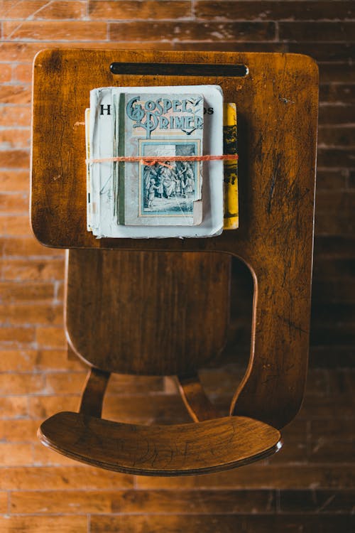 Top View of a Vintage Wooden Desk with Old Books
