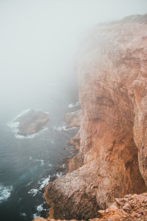Warm Toned Cliff and Fog over the Sea