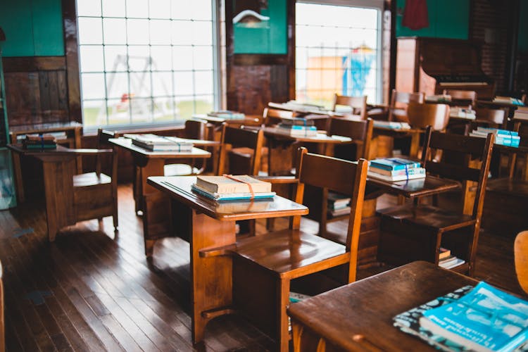 Vintage Classroom With Rows Of Wooden Desks And Chairs