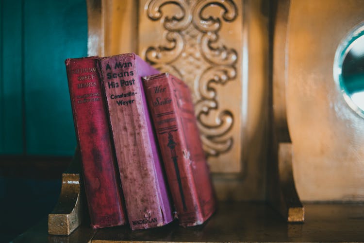 Purple Vintage Books On A Shelve