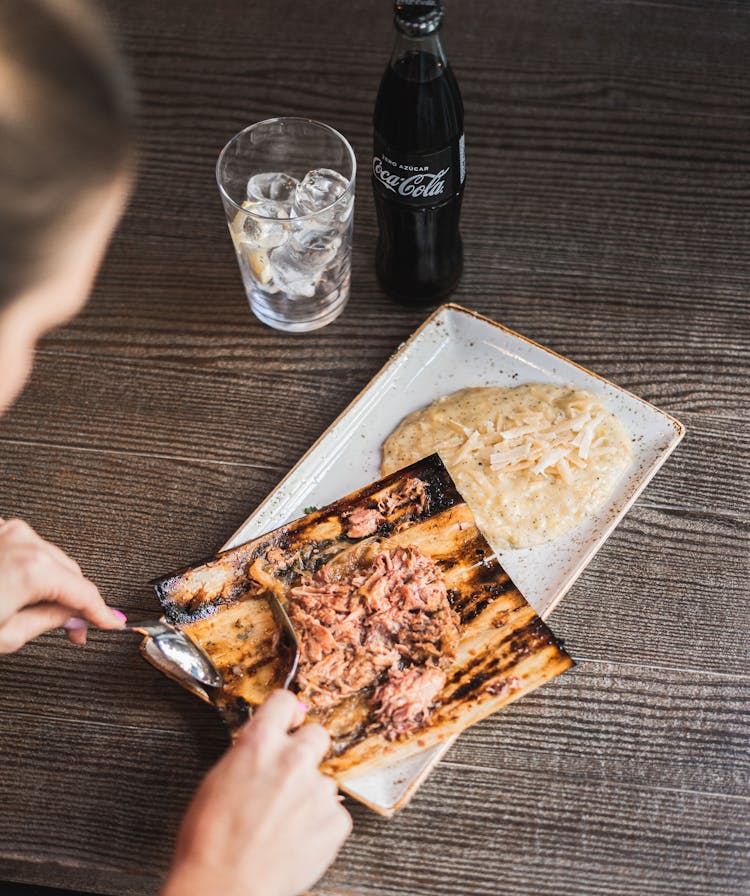 Woman Eating Dinner With Coca Cola