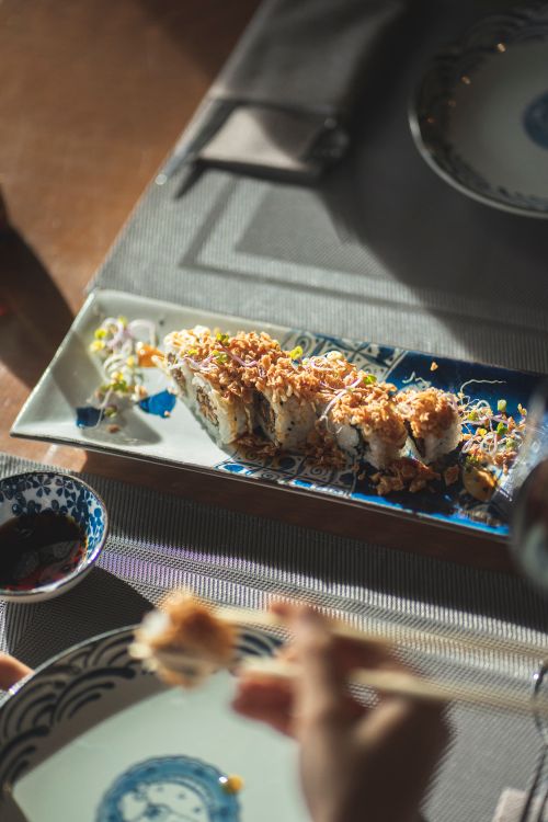 Free Close-up of beautifully plated sushi rolls with soy sauce on a stylish table setting. Stock Photo
