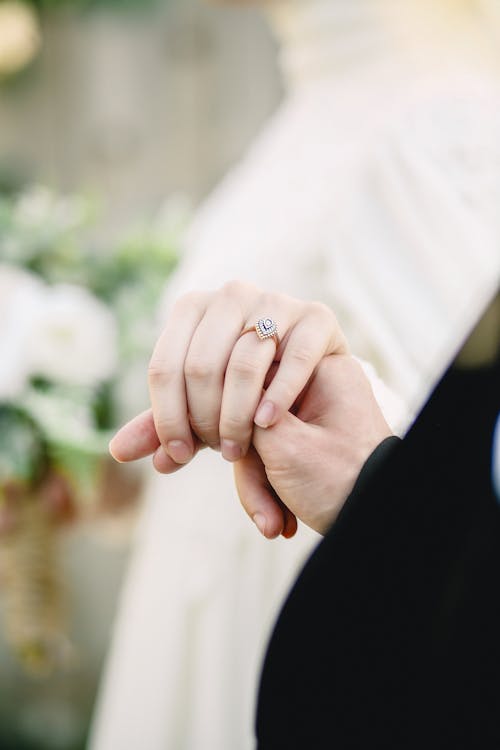 Free Man and Woman with a Ring Holding Hands Stock Photo
