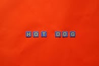 Hot Dog Sign on Red Background