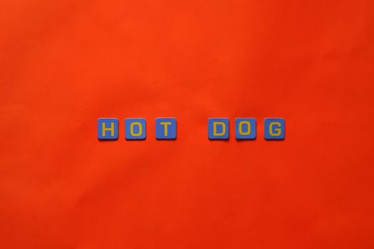 Vibrant letters spelling 'HOT DOG' against a striking red backdrop, perfect for creative design.