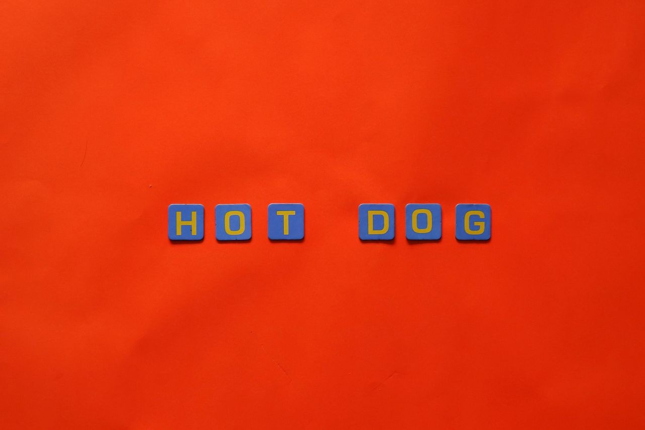 vibrant letters spelling hot dog against a striking red backdrop perfe