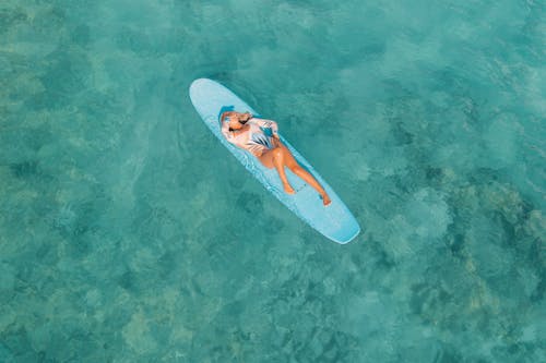 A Sexy Woman Lying on the Surfboard