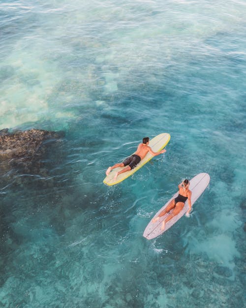 Two People Surfing on the Beach