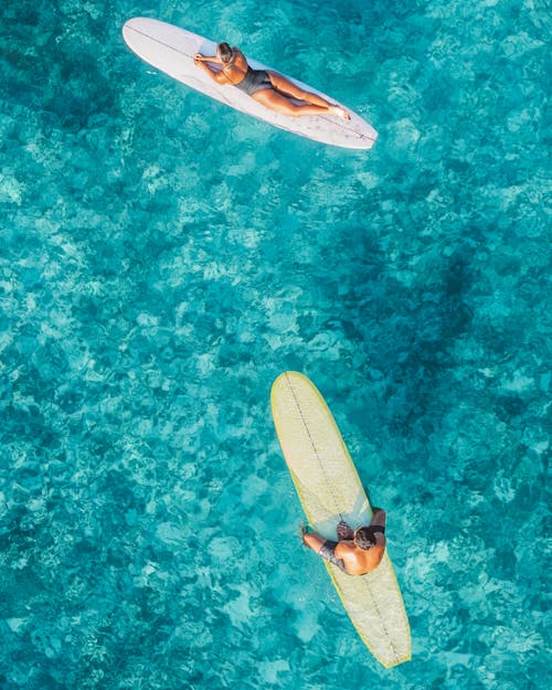A Couple Relaxing on Their Surfboards