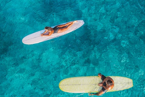 Woman and Man on Surfboards