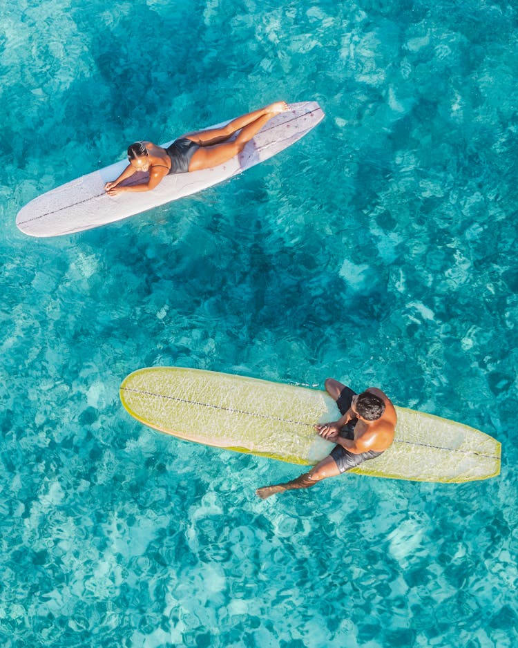 Woman And Man On Surfboards