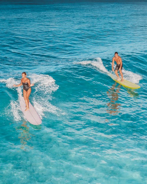 Woman and Man Surfing