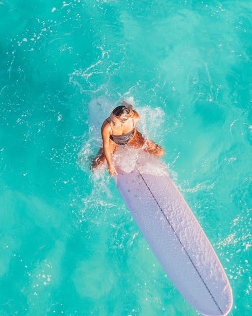 Top View of Woman Sitting on a Surfboard 