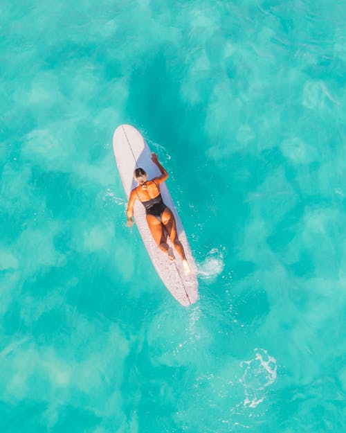 A Sexy Woman Surfing on the Beach