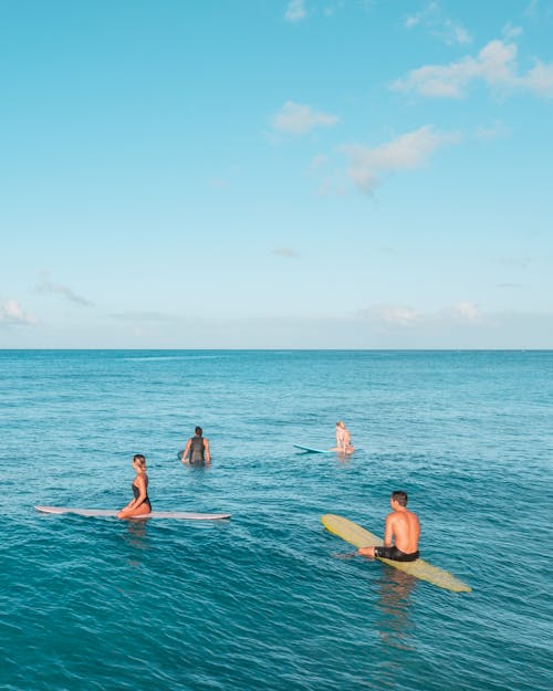 People Surfing in Turquoise Water 