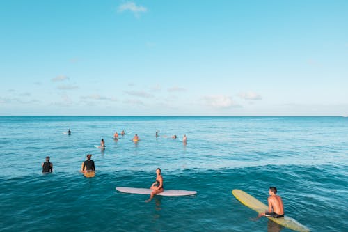 Tourists Relaxing on Surfboards on the Sea