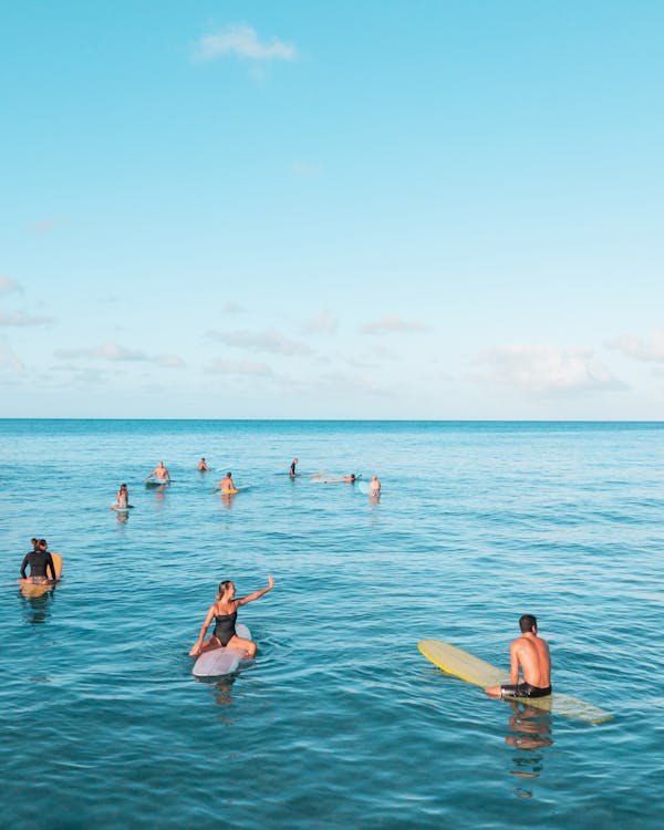 People Surfing on the Beach