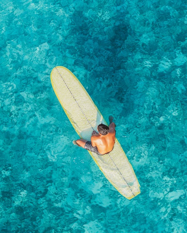 Man Sitting on Surfboard