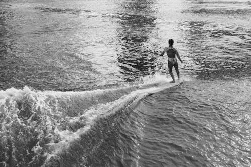 A Woman Surfing on Sea 
