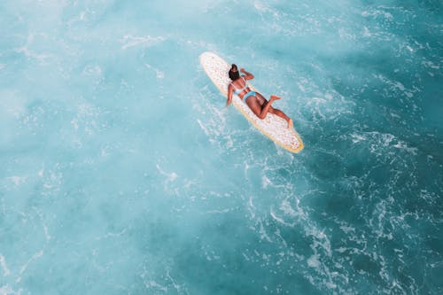 Aerial View of Woman Lying on a Surfboard 