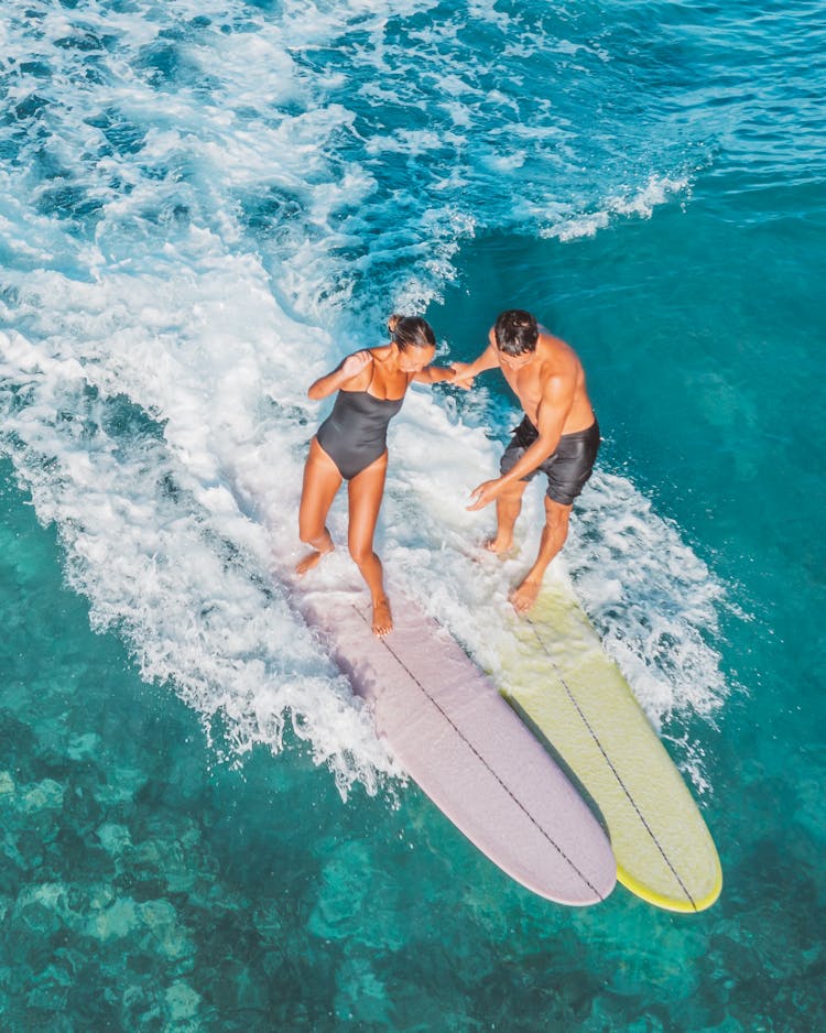 Man And Woman Surfing Together 