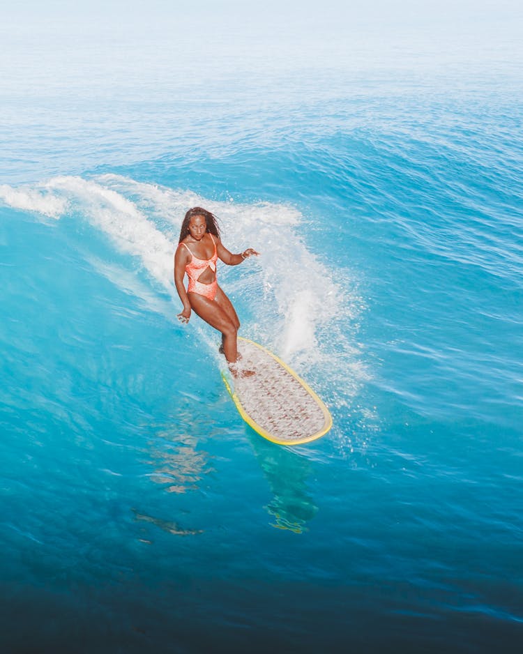 Woman Surfing On Wave