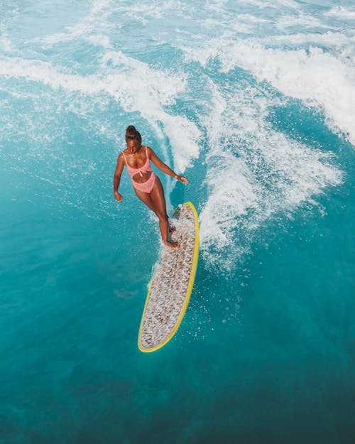 A Sexy Woman Surfing on the Beach
