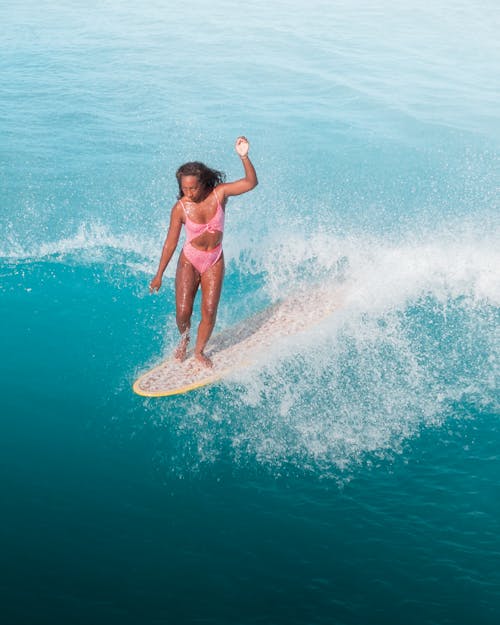 A Woman Surfing the Sea Waves