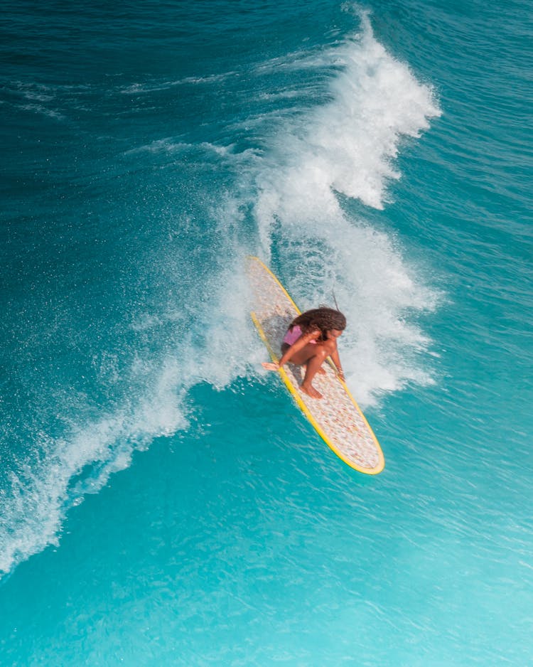 Woman Surfing On Wave